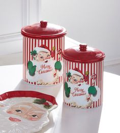 two christmas themed canisters on a table