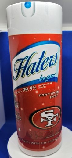 a bottle of toilet cleaner sitting on top of a white stand with blue walls in the background