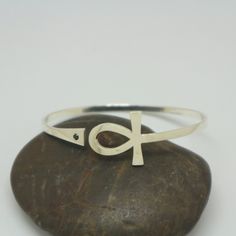 "Silver Ankh Bracelet is handmade with its own uniqueness. It can be bought as a gift for any occasion like birthday gift, wedding gift, travel gift, souvenir and etc. If you need rose gold plating or yellow gold plating, please contact us, we will advice you on the additional fees applicable. You can choose the stone color but it is subject to availability. Please convo us. Base Material: Sterling Silver Size / Depth: 19mm (Approximately) Stone: Black CZ Bangle wrist size: 6'' - 7.5''. Adjustab Symbolic Handmade Bracelets For Friendship, Symbolic Handmade Friendship Bracelets, Handmade Silver Promise Bracelets, Handmade Symbolic Adjustable Bangle, Handmade Symbolic Bangle Bracelets, Black Spiritual Cuff Bracelet As Gift, Spiritual Black Cuff Bracelet As Gift, Handmade Symbolic Bracelets As Gifts, Spiritual Black Cuff Bracelet For Gift