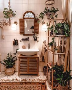 a bathroom that has plants on the wall and a sink in the middle with a mirror above it