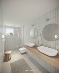 a bathroom with two sinks and mirrors on the wall