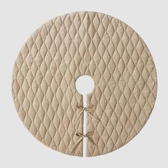 a round rug with a circular design on the front and side, in beige color