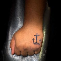 a person with a cross tattoo on their foot