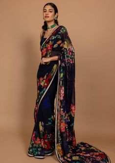 Editor's Note Featuring varun bahl's classic drapes in a midnight blue floral print highlighted with sequins and cutdana hand embroidery. This sari comes with a printed blouse. Note: Option for converting it into a pre-stitched sari Fabric: Georgette & chanderi Color: Blue Component: sari and blouse Sleeve type: Sleeveless Neckline: Square Fit: Fitted blouse Embroidery details: Highlight on print Occasion: Festive Blouse length: 14" inches, sari length: 5.75 Mtr, saree width: 48" inches Care: Dr Floral Print Saree, Varun Bahl, Floral Print Sarees, Floral Saree, Fitted Blouse, Blouse Embroidery, Print Saree, Drape Saree, Blue Saree