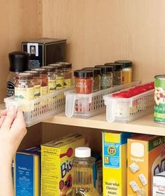 a person picking up food from a pantry shelf