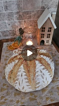 a table topped with a cake covered in frosting next to a birdhouse and candle