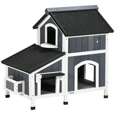 a large dog house with a ramp for the dogs to climb up and down it's side