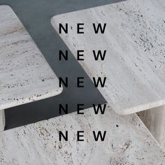 two white marble benches sitting next to each other on top of a cement ground with the words new, new, and new written below them