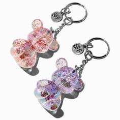 two hearts shaped key chains are shown with the letters b and f on them,