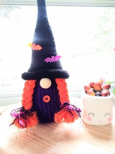 a knitted witch hat sitting on top of a table