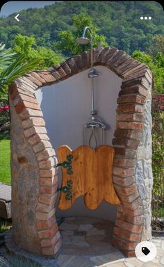 an outdoor shower in the middle of a garden