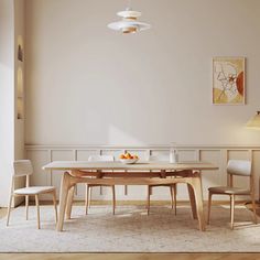 a table and chairs in a room with white walls