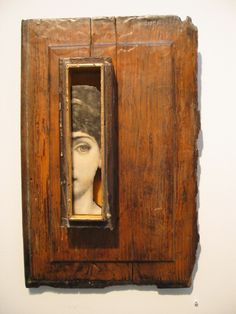 an old wooden frame with a woman's face in it