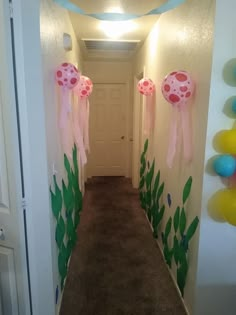 the hallway is decorated with balloons and streamers for an under - sea themed birthday party