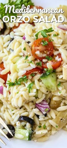 a white plate topped with pasta and vegetables