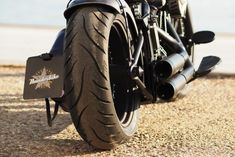 two motorcycles parked side by side in the dirt