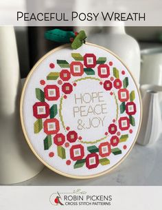 a cross stitch hoop with the words hope, peace and joy on it is shown