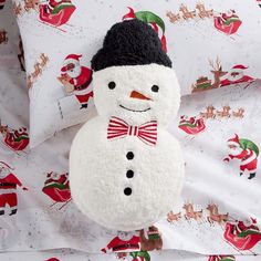 a white snowman with a black hat and bow tie on it's head