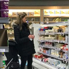 a woman standing in front of a grocery store