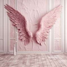 a pink wall with two angel wings on it