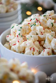 a bowl filled with white and green sprinkles on top of a table