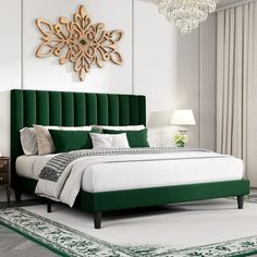 a bedroom with a green headboard and chandelier on the wall above it