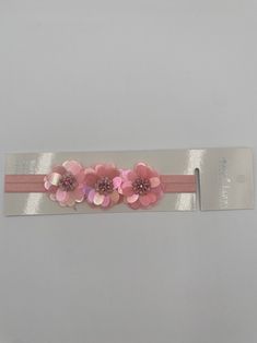 Your sweet little cherub will be the cutest flower in the garden with this playful, pretty baby headband! Featuring three cheerful flowers on a stretch headband, this accessory is the perfect way to add a touch of fresh, flowery flair to your infant's ensemble. It's also comfy and secure enough to put up with your litt Stretch Headband, Baby Headband, Floral Baby, Baby Headbands, In The Garden, The Cutest, The Garden, Blossom, Flowers