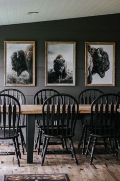 a dining room table with chairs and pictures on the wall above it, along with rugs