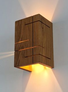 a wooden light fixture mounted to the side of a wall