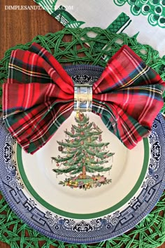 a plate with a christmas tree on it and a red bow tied around the edge