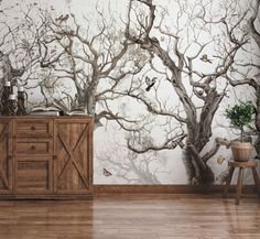 a room with a tree mural and wooden flooring