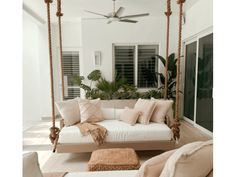 a white couch sitting on top of a wooden swing