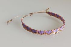 Hey there!🌟 I'm so excited to share some of my handmade bracelets with you! Each one is crafted using delicate, high-quality Miyuki Delica beads (size 11/0). These beads are known for their uniform shape and vibrant colors, making them perfect for creating unique patterns. Some bracelets feature subtle, elegant colors, while others have a pop of spicy neon hues. Either way, they look fabulous paired with your favorite gold or silver jewelry. ☆ ☆ ☆ One of the best things about these bracelets is Adjustable Bohemian Purple Bracelet, Gold Or Silver Jewelry, Handmade Purple Multi-strand Bracelet, Bohemian Nickel-free Purple Bracelets, Purple Hand-strung Bohemian Bracelet, Bohemian Nickel-free Purple Bracelet, Miyuki Delica Beads, Elegant Colors, Bracelet Boho