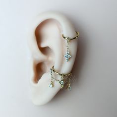 a pair of ear piercings on top of each other