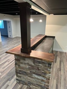 an empty room with wood flooring and stone counter top