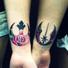 two people with matching tattoos on their arms holding hands in the shape of roses and crescents