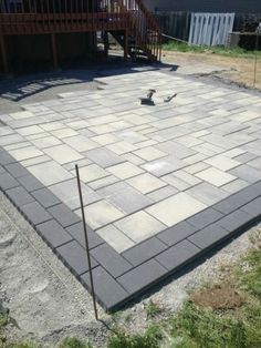 an outdoor patio being built in the middle of a yard