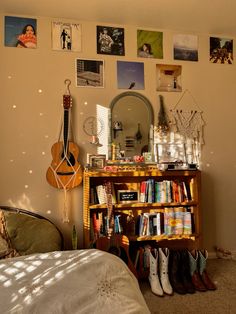 a bedroom with a book shelf, mirror and many pictures on the wall