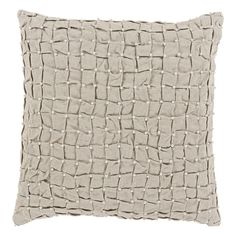 a white pillow that is made out of fabric and has small squares on the front