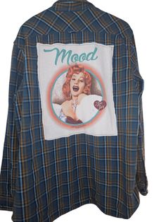 This flannel shirt is perfect for anyone who loves the classic sitcom "I Love Lucy". The graphic on the back features the show's iconic logo and is sure to catch the eye of any fan. Made with comfortable fabric, this shirt is perfect for casual wear and comes in a size XL for men and women. The blue color adds a pop of color to any outfit and the long sleeves make it perfect for cooler weather. This button-up shirt is a must-have for any fan of "I Love Lucy" and is sure to become a favorite in y Retro Cotton Flannel Shirt For Fall, Painted Flannel Shirt, Vintage Flannel Tops For Streetwear, Plaid Flannel Shirt With Graphic Print, Plaid Cotton Flannel Shirt With Graphic Print, Retro Plaid Top With Graphic Print, Oversized Blue Long Sleeve Flannel Shirt, Vintage Flannel Top With Graphic Print, Vintage Plaid Tops With Graphic Print