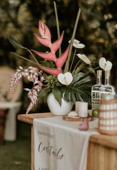 a table with flowers and bottles on it