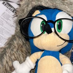 a close up of a stuffed animal wearing glasses