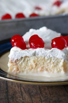 a piece of cake with cherries on top is sitting on a plate and ready to be eaten