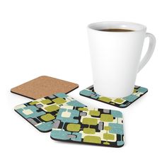 a cup of coffee and coasters on a white surface