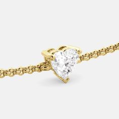 The Cari heart-shaped diamond bracelet is a timeless and elegant way to show your love and commitment. This bracelet features a sparkling heart-shaped diamond that is set in 14k gold. Features: Heart-shaped diamond solitaire Cruelty free, Real, Lab-grown Diamond Diamond Color: G-J & Clarity: VS-SI Available in 14k yellow, white, rose gold and platinum (on request) 100% recycled gold Gift Idea For Valentines Day, Eternity Band Engagement Ring, Diamond Band Engagement Ring, September Birthstone Rings, October Birthstone Rings, Diamond Heart Ring, Diamond Size Chart, Diamond Free, Heart Shaped Diamond