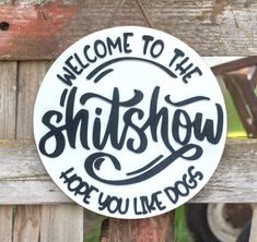 a sign that says, welcome to the shitshow here you like dogs