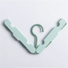 an umbrella shaped paper clip on a white background with the letter v cut out from it