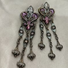 This Is A Beautiful Feminine Design In An Antiqued Gold Finish With A Soft Pastel Brushed Patina Finish In Pink Lavender And Greenish Blue. 3.25” L Surgical Steel Posts Vintage 1980s ( From My Original Wearable Art Gallery Ny Vint Box “E” Purple Drop Chandelier Earrings For Formal Occasions, Ornate Purple Dangle Earrings, Vintage Purple Earrings For Party, Ornate Purple Pierced Earrings, Purple Clip-on Earrings, Vintage Purple Drop Earrings, Purple Metal Chandelier Earrings For Gifts, Purple Metal Chandelier Earrings As Gift, Elegant Purple Dangle Clip-on Earrings