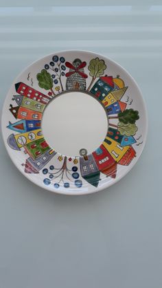 a white plate with houses painted on it