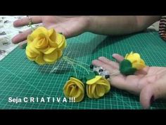 someone is making some flowers out of paper